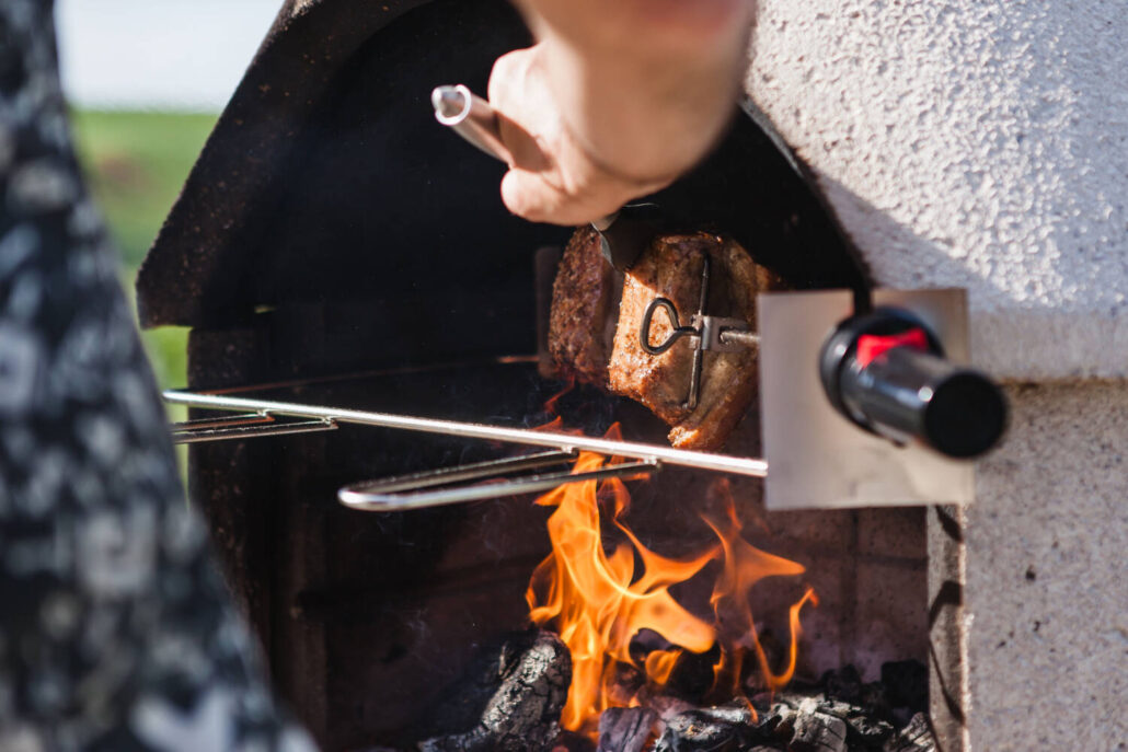 BBQing meat in the Buschbeck outdoor fireplace